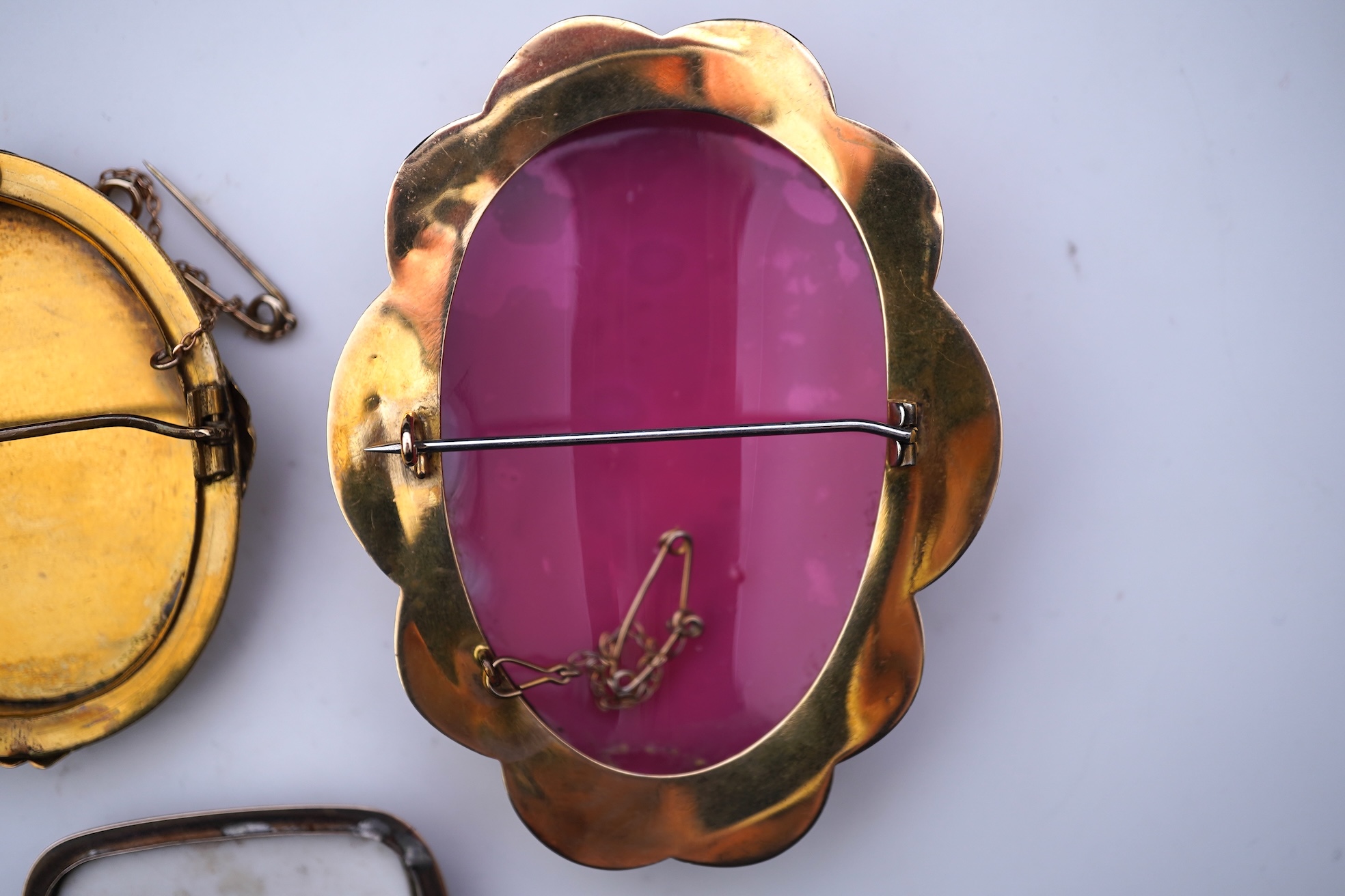 Three painted enamel brooches, mid 19th century